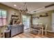 A sunny kitchen with an eat-in area with sliding glass door and stainless steel pot rack at 3120 Mercer Dr., Conway, SC 29526