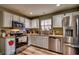 The kitchen features stainless steel appliances, white cabinets, and wood grain flooring at 3120 Mercer Dr., Conway, SC 29526