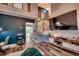 Open-concept living area showcasing a staircase, vaulted ceilings, dark accent wall, and stylish decor at 3120 Mercer Dr., Conway, SC 29526