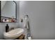 Cozy powder room featuring a pedestal sink, accent mirror and modern fixtures at 3120 Mercer Dr., Conway, SC 29526