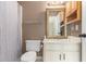 Cozy bathroom features a framed mirror, shower with curtain, and neutral finishes at 3429 Mishoe St., Loris, SC 29569