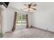 Bright bedroom with neutral carpet, ceiling fan, and large windows at 3429 Mishoe St., Loris, SC 29569