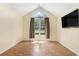 Bedroom with a high ceiling, large window, and TV at 3429 Mishoe St., Loris, SC 29569