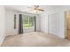 Cozy bedroom featuring a ceiling fan, natural light, and double closets for ample storage at 3429 Mishoe St., Loris, SC 29569