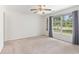 Bright bedroom with large window, ceiling fan, and neutral carpet at 3429 Mishoe St., Loris, SC 29569