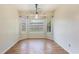 Bright dining room featuring a large window and stylish pendant lighting, creating an inviting space for meals at 3429 Mishoe St., Loris, SC 29569
