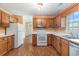 The kitchen offers wooden cabinets, light countertops, and modern appliances at 3429 Mishoe St., Loris, SC 29569