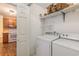 Functional laundry area with washer, dryer, shelving and easy access to the kitchen at 3429 Mishoe St., Loris, SC 29569