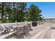 Outdoor deck with a dining table set and BBQ grill surrounded by trees at 3808 Mayfield Dr., Conway, SC 29526