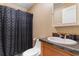 Bathroom with toilet, sink with cabinet, and dark shower curtain at 3808 Mayfield Dr., Conway, SC 29526