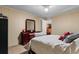Bedroom with ceiling fan, cherry dresser, and door to hallway at 3808 Mayfield Dr., Conway, SC 29526