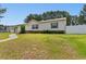 Inviting single-story home with a well-kept lawn and a white fence at 3808 Mayfield Dr., Conway, SC 29526