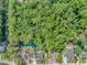 Aerial view of property featuring a pond and multiple structures surrounded by lush greenery at 3827 El Duce Pl., Myrtle Beach, SC 29588