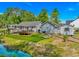View of backyard featuring a spacious deck, lush artificial turf, and a charming pond at 3827 El Duce Pl., Myrtle Beach, SC 29588