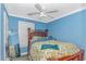Bright bedroom with yellow floral comforter, a ceiling fan, and light blue walls at 3827 El Duce Pl., Myrtle Beach, SC 29588