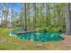 Lush backyard view features a tranquil pond with a fountain and mature trees at 3827 El Duce Pl., Myrtle Beach, SC 29588