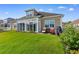 Well-maintained backyard with green grass, patio seating, and views of the home's exterior and landscaping at 388 Hillsborough Dr., Conway, SC 29526