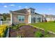 Lush backyard featuring green lawn, patio seating area, and a view of the house exterior at 388 Hillsborough Dr., Conway, SC 29526