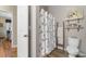 Cozy bathroom features a toilet, decorative ladder, and stylish shower curtain at 388 Hillsborough Dr., Conway, SC 29526