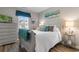 Cozy bedroom with a queen bed, blue accents, and a bright window for natural light at 388 Hillsborough Dr., Conway, SC 29526