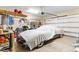 Spacious garage featuring a covered vehicle, storage shelves, and a roll-up door for secure parking and organization at 388 Hillsborough Dr., Conway, SC 29526