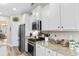 Well-lit kitchen features stainless steel appliances, granite countertops, and white cabinets at 388 Hillsborough Dr., Conway, SC 29526