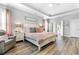 Spacious main bedroom featuring a trey ceiling, plush bedding, and hardwood floors at 388 Hillsborough Dr., Conway, SC 29526
