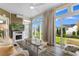 Bright sunroom with large windows, wood floors, and comfortable seating creates a relaxing atmosphere with outdoor views at 388 Hillsborough Dr., Conway, SC 29526
