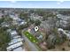 Aerial view of long, low, home with palm trees out front and manicured lawn, surrounded by mature trees and foliage at 390 Boundary Ave., Murrells Inlet, SC 29576