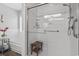 Clean bathroom with a glass shower, bathtub, and wooden bench at 390 Boundary Ave., Murrells Inlet, SC 29576