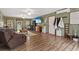 Comfortable living room featuring hardwood floors, a ceiling fan, and outside views at 390 Boundary Ave., Murrells Inlet, SC 29576