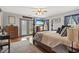 Spacious primary bedroom with hardwood floors and a large bed at 390 Boundary Ave., Murrells Inlet, SC 29576