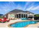 Inviting backyard featuring a swimming pool, lounge chairs, and covered patio seating at 413 Wine Ct., Conway, SC 29527