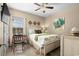 Comfortable bedroom with a floral patterned bedspread, wood floors, and a writing desk at 413 Wine Ct., Conway, SC 29527