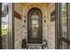 Elegant front door with decorative metalwork, flanked by sconces and charming decor at 413 Wine Ct., Conway, SC 29527