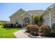 Beautifully landscaped front exterior with a brick facade and arched front door at 413 Wine Ct., Conway, SC 29527