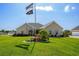 Beautiful brick home with manicured lawn, colorful flowerbeds, and decorative flagpole at 413 Wine Ct., Conway, SC 29527