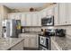 Modern kitchen with stainless steel appliances, granite counters, and custom cabinets at 413 Wine Ct., Conway, SC 29527