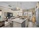 Open-concept kitchen features a large island, granite counters, and stainless steel appliances at 413 Wine Ct., Conway, SC 29527