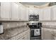 Kitchen features stainless steel appliances, granite countertops, and custom cabinets at 413 Wine Ct., Conway, SC 29527
