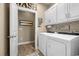 Well-organized laundry room with washer, dryer, storage cabinets, and laundry-themed decor at 413 Wine Ct., Conway, SC 29527