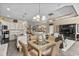 Open-concept living room features a kitchen island with seating and stylish light fixtures at 413 Wine Ct., Conway, SC 29527