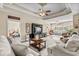 Spacious living room featuring tray ceiling, comfortable seating, and large windows at 413 Wine Ct., Conway, SC 29527