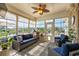 Bright sunroom with ample windows, comfortable seating, ceiling fan, and outdoor views at 413 Wine Ct., Conway, SC 29527