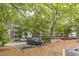 Exterior of the home in a parking lot with mature trees in a quiet community at 415 Ocean Creek Dr. # 2330, Myrtle Beach, SC 29572