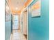 Hallway with beach themed decorations, light tile, and doors leading to the unit's main living space at 415 Ocean Creek Dr. # 2330, Myrtle Beach, SC 29572