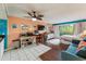 This comfy living area includes a dining table, bed, television, couch, and balcony access at 415 Ocean Creek Dr. # 2330, Myrtle Beach, SC 29572