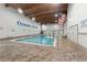 Indoor swimming pool at Ocean Creek with American flag, lifeguard signs, and tables for residents at 415 Ocean Creek Dr. # 2330, Myrtle Beach, SC 29572
