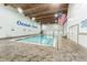Indoor swimming pool at Ocean Creek with American flag, lifeguard signs, and tables for residents at 415 Ocean Creek Dr. # 2330, Myrtle Beach, SC 29572