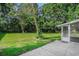 Expansive backyard with lush green grass, mature trees, and a glimpse of the screened-in porch at 4311 Bradford Circle, Myrtle Beach, SC 29588